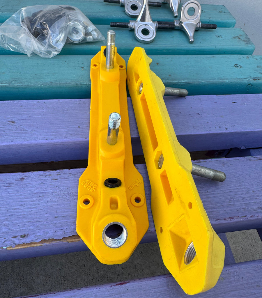 Yellow metal brackets on a blue wooden surface