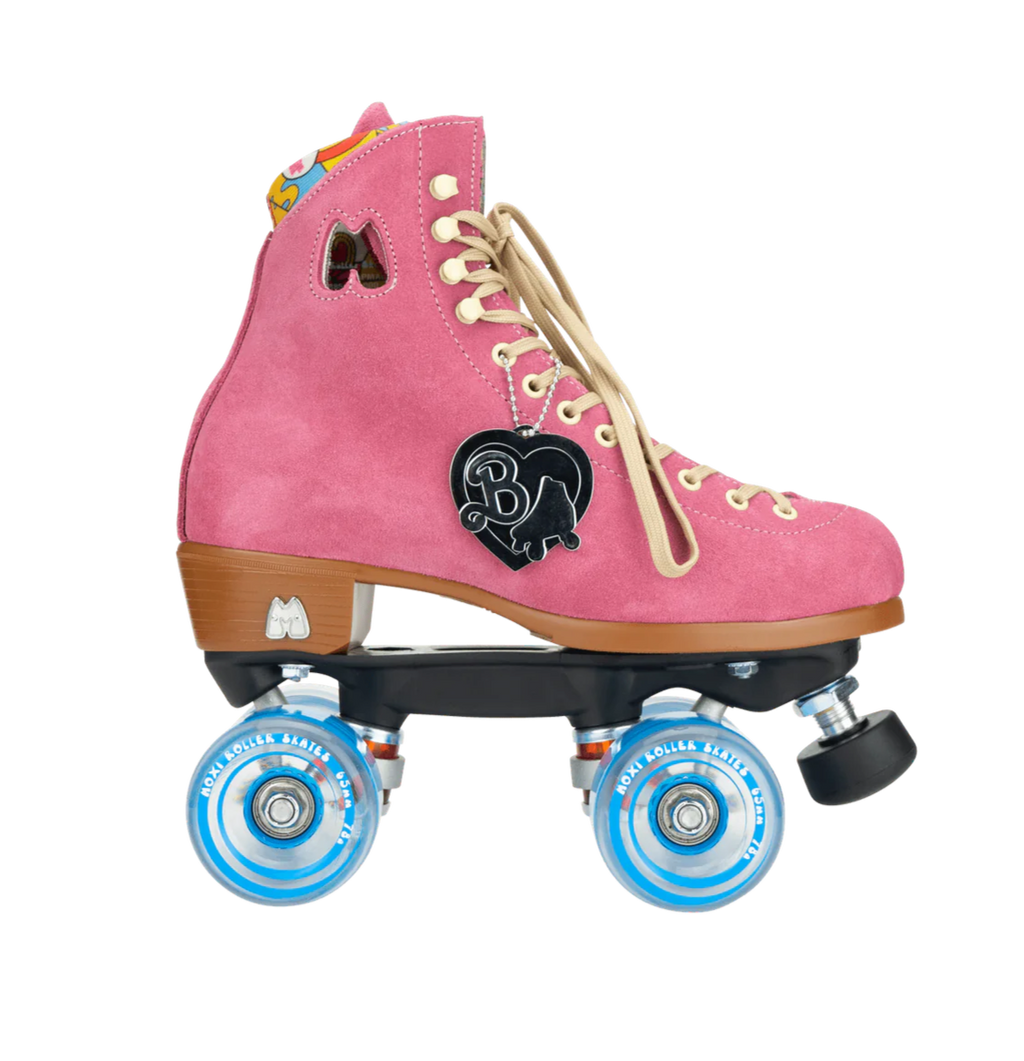 A pair of pink Moxi Lolly roller skates with white laces and blue wheels, featuring Barbie branding on the ankle support.