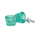 Turquoise glittery earbud cases with a silver charging cable on a white background